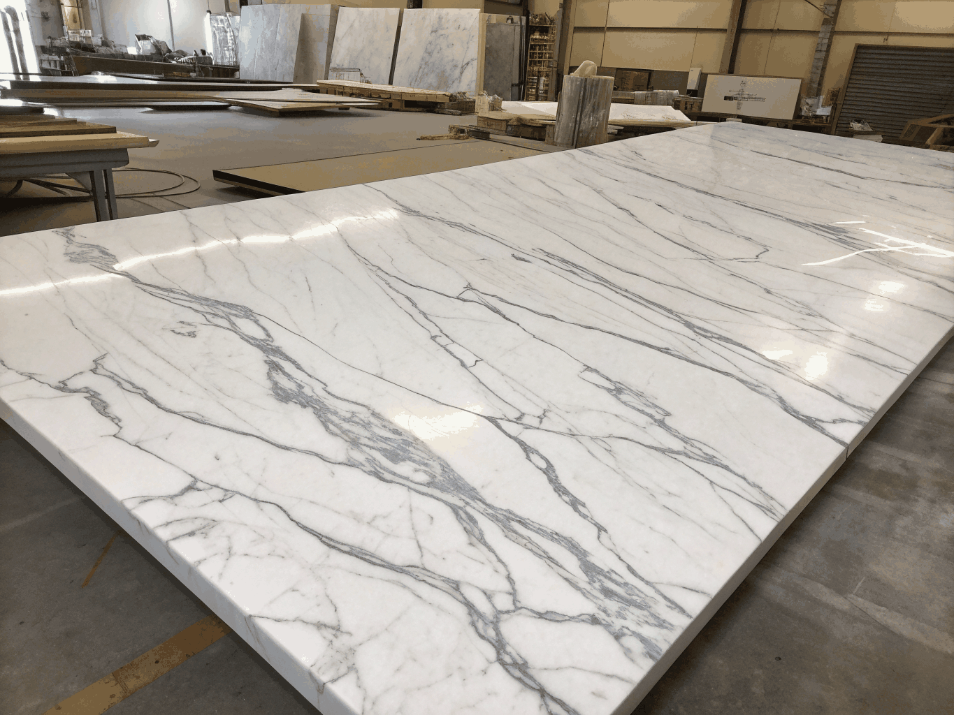Pure white natural marble slab with subtle grey movement